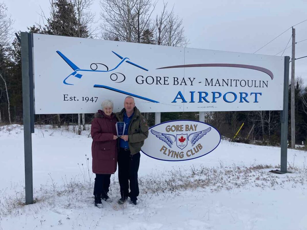 Nancy Richards,left, presents Wade Cook with the Canadian Owners and Pilots Association (COPA) Director’s Award. The Gore Bay Flying Club/COPA Flight 201 paid tribute to instructor Wade Cook who is leaving the club and advancing his professional pilot career in Windsor.