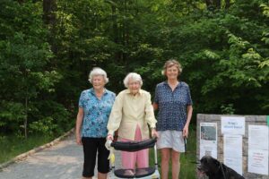 Madeleine Wagg-Becks, centre, along with her daughter Gail Meehan and her granddaughter Diane Meehan stand at the soft reopening of Wagg’s Woods Trail. photo by Maggie Leclair.