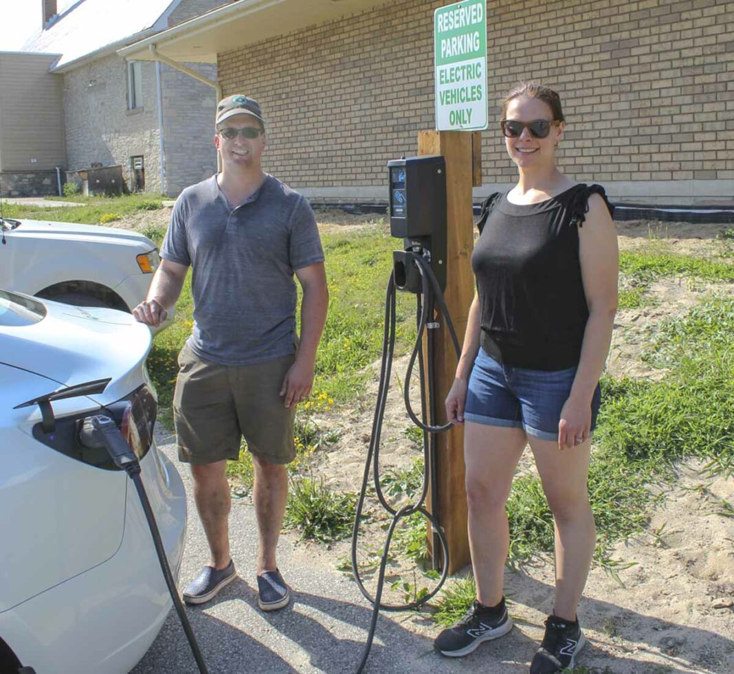 Brad and Anya Wright charge up their car at the electric vehicle station the couple paid for in Gore Bay. The unit was installed by the town.