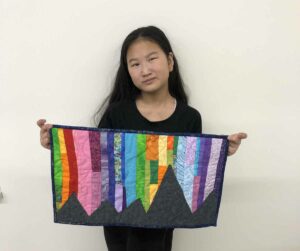 Violet Bell with her quilt.